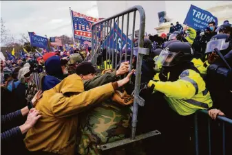  ?? Kent Nishimura / Los Angeles Times 2021 ?? Backers of former President Donald Trump clash with police on Jan. 6, 2021, outside the U.S. Capitol. More than 790 people have been charged with federal crimes related to the melee.