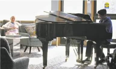  ?? Photos by Manjula Varghese / The Chronicle ?? Christophe­r Nguyen has been playing for residents of the Lodge, an assisted living center in Alameda, for five years. His musical passion started when, at age 5, he started calling out the notes to songs on the radio.