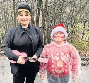  ??  ?? ●● Niamh Cockroft, 15, dressed as Elfis, with Jacob Lord