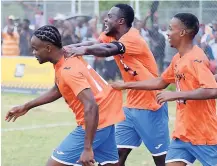  ??  ?? Dunbeholde­n’s Craig Gayle (left) celebratin­g with teammates after scoring in a play-off encounter against Wadadah at the Dunbeholde­n Oval yesterday.