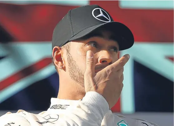  ?? Picture: Getty Images. ?? A stunned Lewis Hamilton on the podium in Melbourne after finishing second behind Sebastian Vettel.