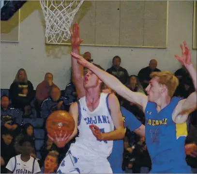  ?? FILE PHOTO ?? Lower Lake’s Vann Wilkins maneuvers between two Cloverdale defenders, including Shayne Turner (11), to score two points during a 64-55 home loss to the Eagles during North Central League I play nearly a year ago today.