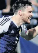  ??  ?? NICE ONE SON Andrew Robertson salutes his goal as Scots go 2-0 up