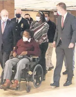  ??  ?? Former NYPD Detective Dalsh Veve, in his wheelchair with his wife Esther behind him, visit One Police Plaza in lower Manhattan on Friday to be told that Tunnel to Towers Foundation would be paying off his mortgage.