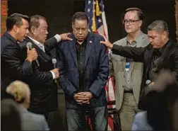  ?? Mel Melcon Los Angeles Times ?? PASTORS pray for Larry Elder at a campaign town hall Thursday in Downey. Elder has made a career blaming Black people for many social problems.