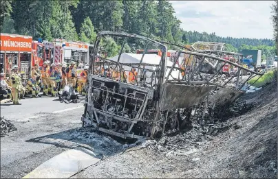  ?? AP PHOTO ?? The wreckage of a burnt-out bus remains at the scene of a fatal accident near Muenchberg, Germany, Monday.