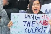  ?? HT FILE ?? A woman holding a placard during a protest against the Kathua rape and murder incident, in Srinagar.