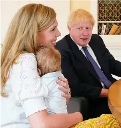  ??  ?? Family: Carrie Symonds, Wilfred and Boris Johnson