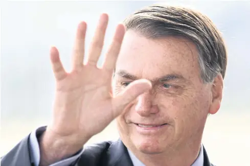  ?? AFP ?? Brazilian President Jair Bolsonaro gestures as he speaks to supporters while leaving Alvorada Palace in Brasilia, on Wednesday.