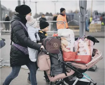  ?? ?? Refugees fleeing Ukraine arrive at the Vysne Nemecke border crossing in Slovakia.