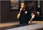  ?? PICTURE: ASSOCIATED PRESS ?? Ahmad Taher, food and beverage manager for Citymax Hotels in Dubai, United Arab Emirates, prepares for attempting the world’s longest domino drop shot last night in the hotel’s Huddle Sports Bar & Grille in Bur Dubai .
