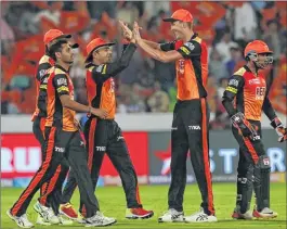  ??  ?? Sunrisers Hyderabad players celebrate after taking a Rajasthan Royals wicket during their IPL match in Hyderabad on Monday.