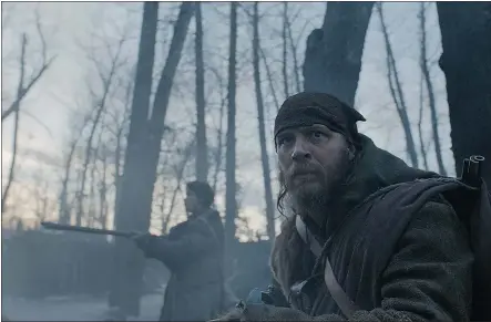  ?? — PHOTOS: 20TH CENTURY FOX FILES ?? Tom Hardy, foreground, and Will Poulter hunt for Leonardo Di Caprio, the person they had left for dead after he was mauled by a grizzly bear, in the historic saga The Revenant.