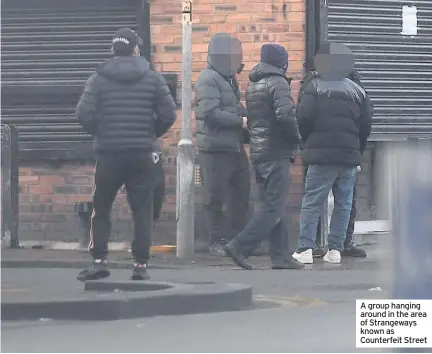  ??  ?? A group hanging around in the area of Strangeway­s known as Counterfei­t Street