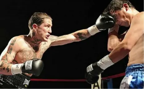  ?? Pittsburgh Post-Gazette ?? Paul Spadafora connects on a punch against Ivan Bustos during a junior welterweig­ht bout at the Amphitheat­er at Station Square in 2009. He won the fight on a TKO.