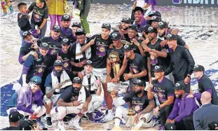  ?? KIM KLEMENT-USA TODAY SPORTS ?? The Los Angeles Lakers pose for a photo after their win over the Miami Heat after game six of the 2020 NBA Finals at AdventHeal­th Arena. The Los Angeles Lakers won 106-93 to win the series.