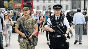  ?? Picture: GETTY IMAGES ?? UNUSUAL SIGHT: An armed soldier and police officer patrol in a busy street in Britain’s capital city, London, yesterday
