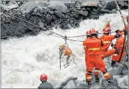  ?? Picture: GETTY IMAGES ?? RESCUE EFFORT: A rescue dog is sent on a zipline across a river after the landslide in Tibetan China