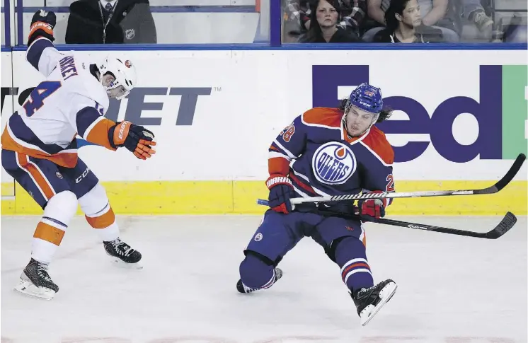  ?? DAVID BLOOM ?? Ryan Jones, right, is shown playing with the Edmonton Oilers in 2014. Jones played parts of five seasons with the Oilers and suited up for 334 NHL games all told before moving to Germany, where he become a popular member of the Cologne Sharks of the German League. At the age of 34, Jones says this will be his last season of profession­al hockey.