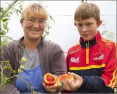  ??  ?? Liya Zagaynova and her son Dmitry Murphy Zagaynova with the unusual tomato.