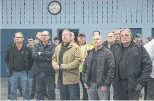  ?? RICK MADONIK TORONTO STAR ?? General Motors workers gather at the offices of Unifor Local 222 in Oshawa on Monday, as they wait to hear the official news of the shutdown of operations at their plant by December 2019.