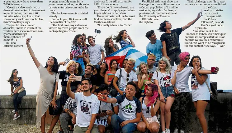  ?? — AFP ?? Cuban YouTubers taking selfies at the Malecon esplanade. Camallerys is among about 50 young Cubans who have become Internet celebritie­s.