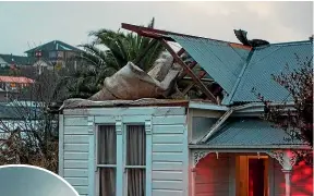  ?? SIMON O’CONNOR/STUFF ?? Roofs were torn off, fences blasted over and windows smashed as the tornado – shown left – ripped into New Plymouth about 5.30pm.