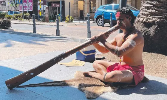  ??  ?? Didgeridoo player Jahmarley Dawson is teaching others about the Indigenous culture while busking. Picture: Madison Mifsud-Ure