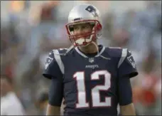  ?? CHARLES KRUPA - THE ASSOCIATED PRESS ?? FILE - In this Aug. 9, 2018, file photo, New England Patriots quarterbac­k Tom Brady smiles as he takes the field to warm up before a preseason NFL football game against the Washington Redskins, in Foxborough, Mass.