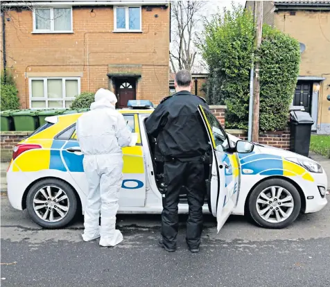 ??  ?? Police forensics officers outside the house in Stockport, Greater Manchester, yesterday where a women alleged that she buried the body of her father after she killed him