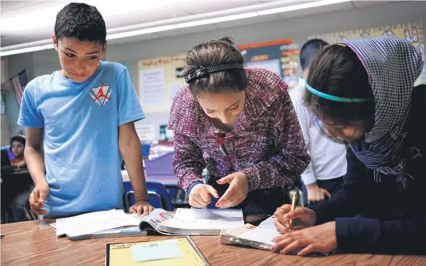  ?? Picture / AP ?? Abdulhamid Ashehneh, 12, works on English language exercises with fellow students in a class filled with refugee children at Cajon Valley Middle School in El Cajon, California.