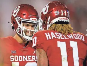  ?? BRYAN TERRY/THE OKLAHOMAN ?? Oklahoma's Caleb Williams and Jadon Haselwood celebrate after a touchdown during a 52-31 win against TCU on Saturday night in Norman.
