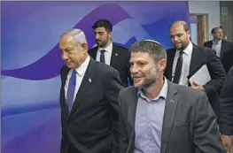  ?? Ronen Zvulun Associated Press ?? ISRAELI Prime Minister Benjamin Netanyahu, left, with Finance Minister Bezalel Smotrich, had pledged not to legalize any more wildcat West Bank outposts.