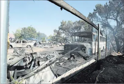  ?? Rick Egan ?? The Associated Press Property destroyed by the fire in Moab, Utah, near Pack Creek on Wednesday. The blaze in Moab, known for its dramatic red rocks, started in a wooded area Tuesday night and quickly spread to homes over less than a square mile,...