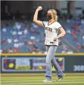  ??  ?? Dr. Cara Christ, Director of Arizona Department of Health Services, throws out the first pitch at Chase Field on Friday night.