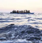  ?? ?? Migrants from Tunisia sail in a wooden boat in the Mediterran­ean sea, Aug. 5, 2022.