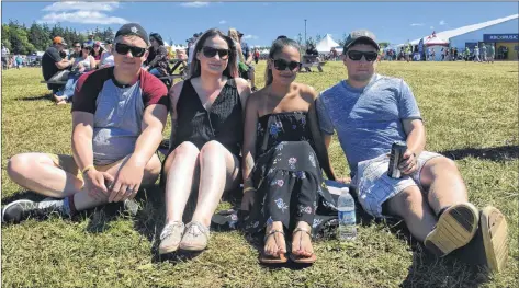  ?? TONY DAVIS/ THE GUARDIAN ?? Brendyn Wendell, from left, and Hailey Friesen travelled with Thandi and Jesse Nagel from Nova Scotia to see the 2018 Cavendish Music Festival. The group sat in the grass taking in a performanc­e Saturday afternoon. Thandi said the concert was a good excuse to visit her sister, who lives in P.E.I.