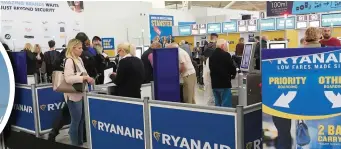  ??  ?? Left: Ryanair CEO Michael O’Leary at a press conference at its HQ in Swords last week. Photo: Colin Keegan. Above: Ryanair check-in desks at London Stansted Airport. Photo: PA. Inset: A Ryanair jet prepares to land at Dublin Airport. Photo: Reuters