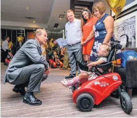  ?? Picture: Art Lesniak ?? HRH The Earl of Wessex speaks to Lexi, three, pictured on Wizzybug at the party