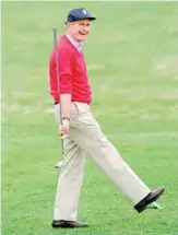  ?? —AFP ?? ANDREWS AIR FORCE BASE: In this file photo taken on April 12, 1992, US President George HW Bush acknowledg­es the cheers of a crowd after teeing off the Andrews Air Force Base Golfe Course.