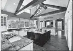  ??  ?? From the beams and archways to the mullion cabinet doors, this kitchen portrays every aspect of traditiona­l style.