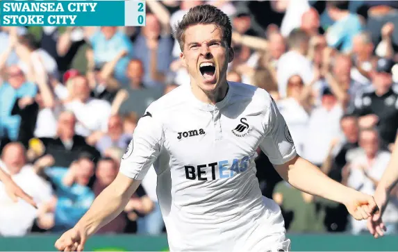  ?? PICTURE: MICHAEL STEELE ?? Tom Carroll celebrates after scoring Swansea’s second goal against Stoke City at the Liberty Stadium yesterday to keep the Swans in the hunt for Premier League safety