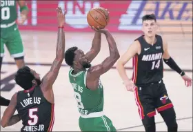  ?? MARK J. TERRILL — THE ASSOCIATED PRESS ?? The Heat’s Derrick Jones Jr. (5) and Tyler Herro (14) defend as Celtics guard Kemba Walker (8) attempts a shot during the second half.