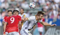  ?? — AP ?? CARSON: FC Dallas forward Cristian Colman (9), of Paraguay, and Los Angeles Galaxy defender Dave Romney, right, vie for the ball during an MLS soccer match, Saturday, in Carson, Calif.