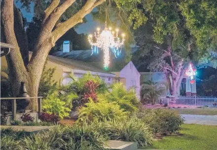  ?? LUIS SANTANA/TAMPA BAY TIMES ?? A home is adorned with yard chandelier­s March 26 in Dunedin, Florida. For some, making the chandelier is part of the fun.