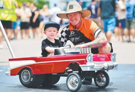  ?? FUN AND GAMES: Brendan Miller of Kirwan and his 3- year- old son Mitchell at the DriveIt NQ rally at Reid Park. ??