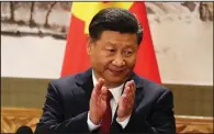  ?? AP/NG HAN GUAN ?? Chinese President Xi Jinping applauds while addressing the media as he introduces new members of the Politburo Standing Committee at Beijing’s Great Hall of the People in October.