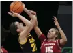  ?? CHARLIE NEIBERGALL — THE ASSOCIATED PRESS ?? Iowa’s Caitlin Clark is fouled Tuesday by Wisconsin’s Sania Copeland.