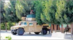  ?? STR/AFP ?? Afghan security forces stand guard on a Humvee vehicle along a roadside in Kunduz on Tuesday.