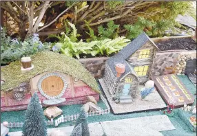  ?? ?? A hobbit hole, a farmhouse with a farm and a train track are among the details of the faerie village.